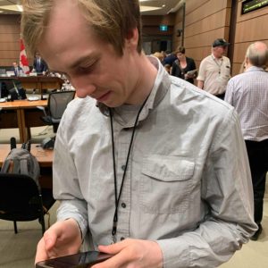 Christian Paas-Lang, intern with The Canadian Press’ Ottawa bureau, checks back with his editors after a parliamentary ethics committees adjourns a meeting on the SNC-Lavalin affair.